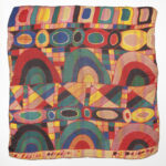 A multi-colored, square textile with geometric shapes.