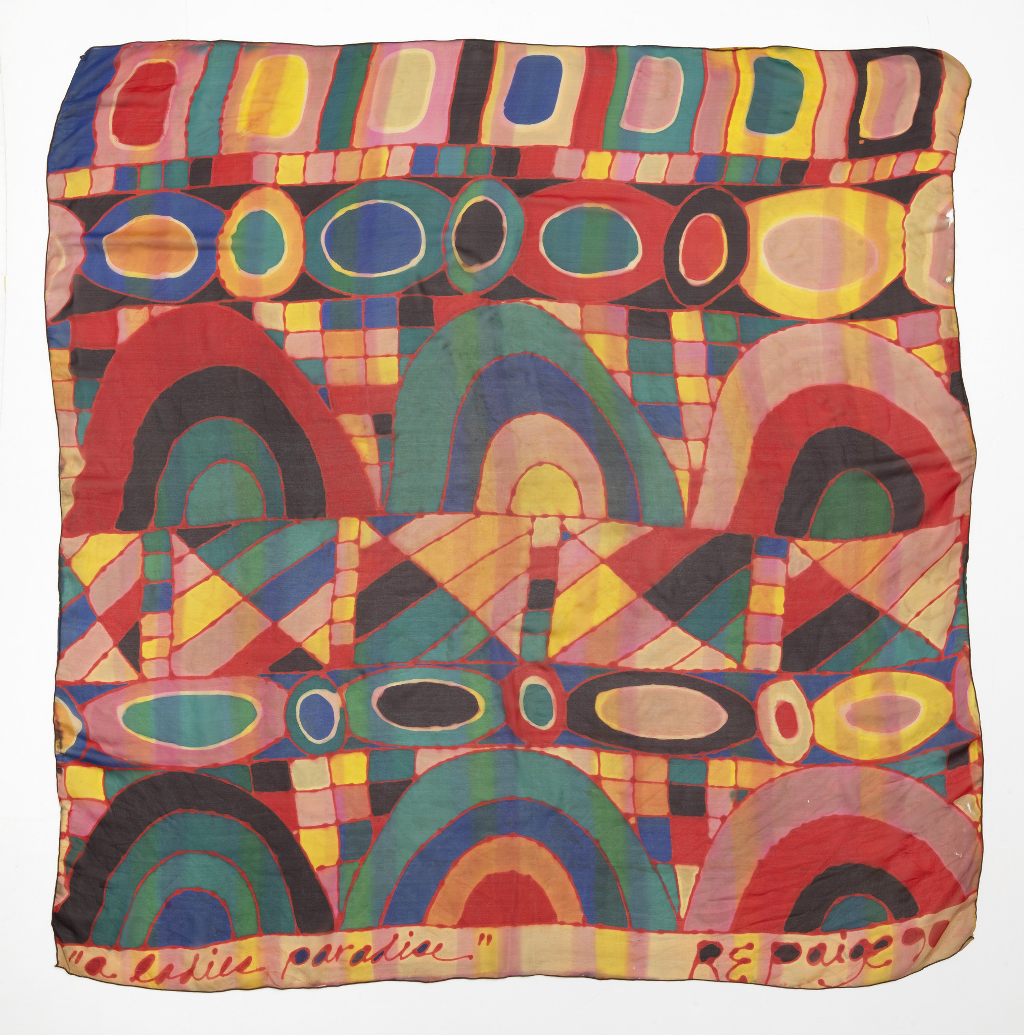 A multi-colored, square textile with geometric shapes.
