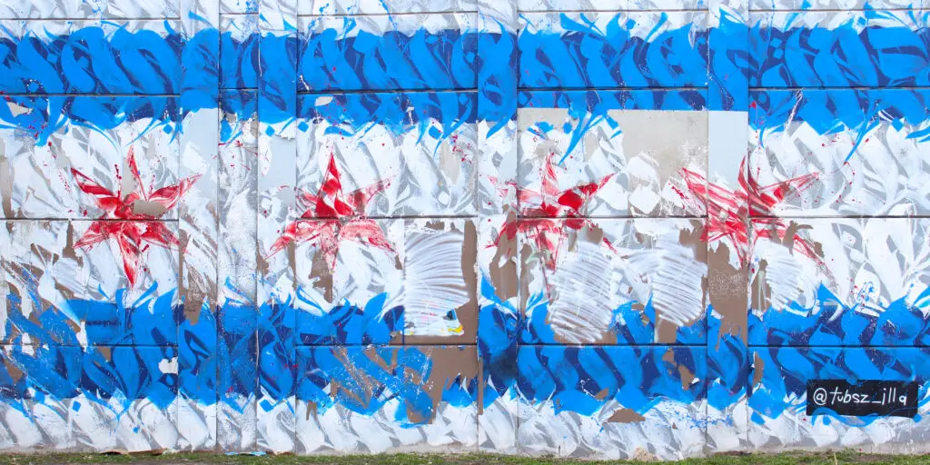 Mural on a building of Chicago's Flag illustrated through stylized typography in red white and blue.