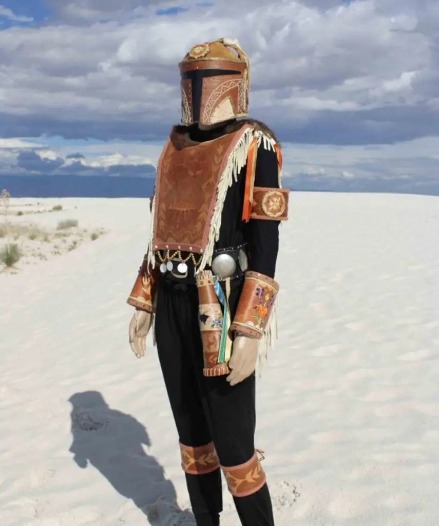 A photo of a figure wearing a set of Madelorian-style armor made of birch bark, including a helmet, breast plate, and adornments on the arms and legs.