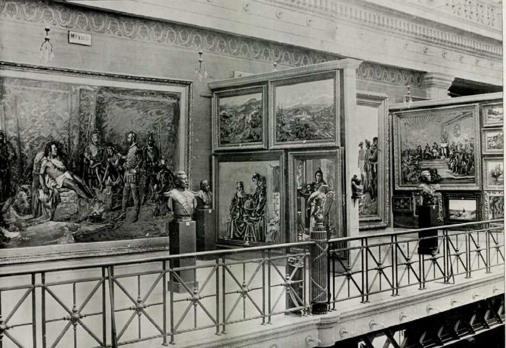 An historical photo showing the interior of the Fine Arts Building at the World's Columbian Exposition in 1893. Floor to ceiling paintings on the walls and sculptures on pedestals.