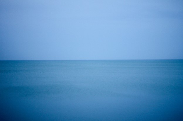 View of a large body of water with the horizon at mid-image.