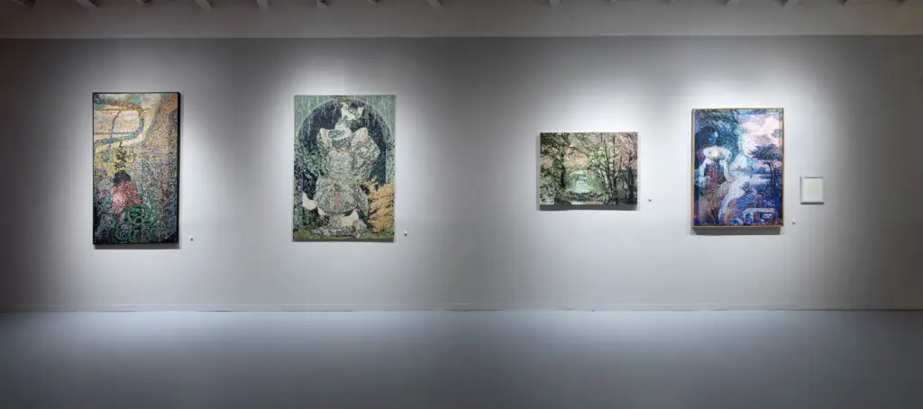 Four artworks installed on a gallery wall.