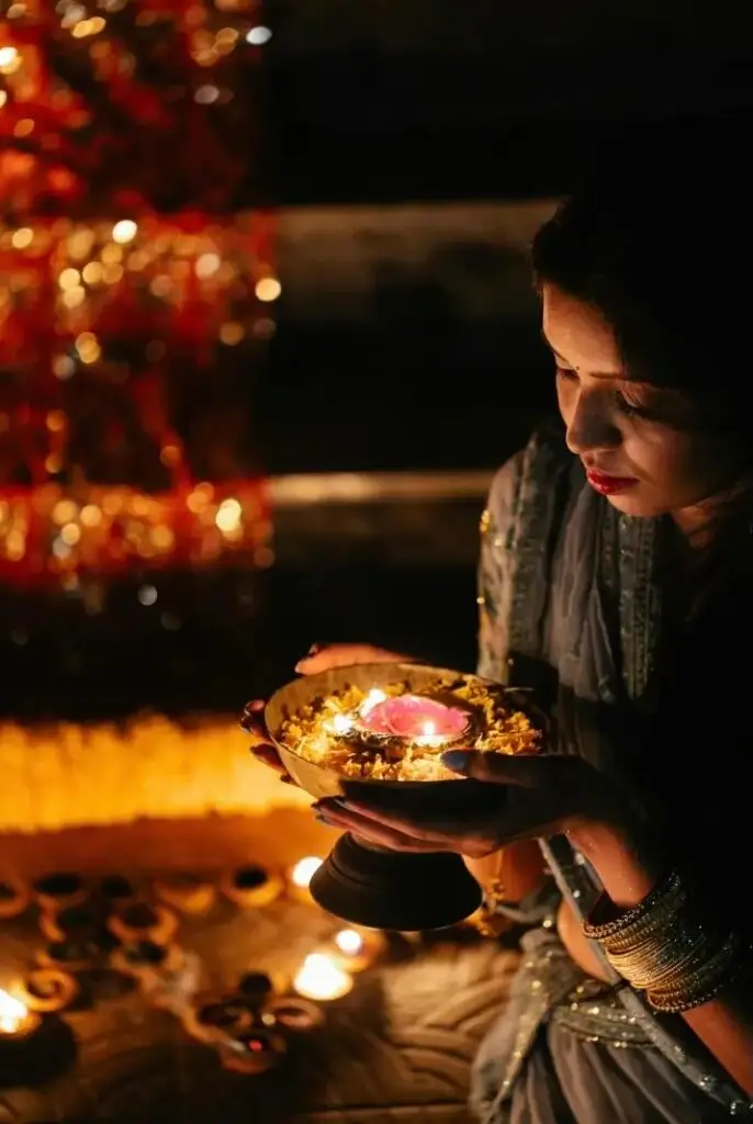 A person with a hand-held bowl with a flame.