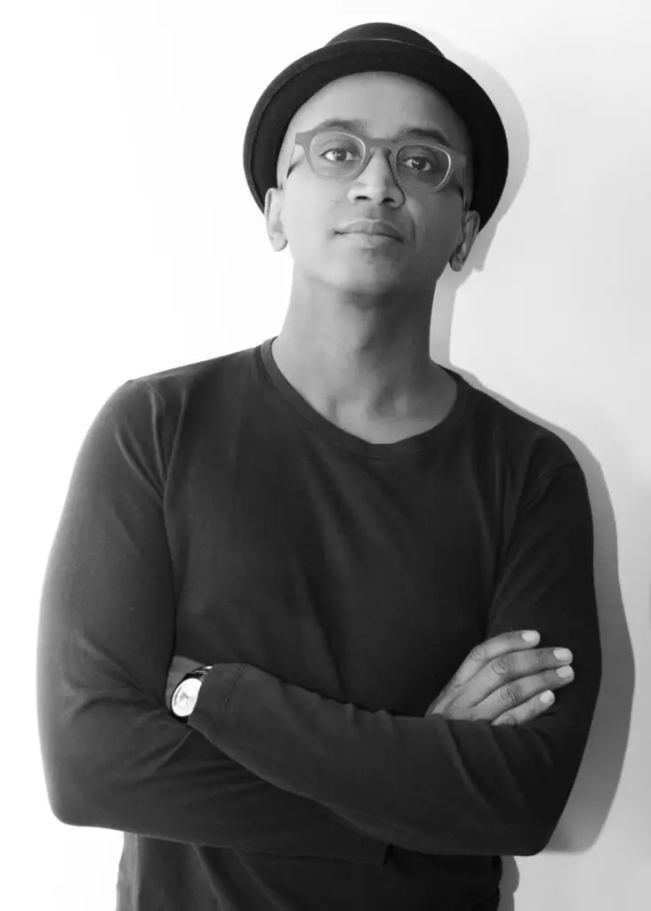 Headshot of Dawit L. Petros wearing glasses, a hat, and a long sleeved t-shirt.