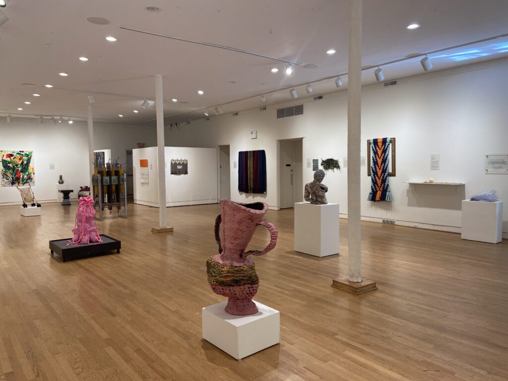 View of an art gallery with sculptures on pedestals.